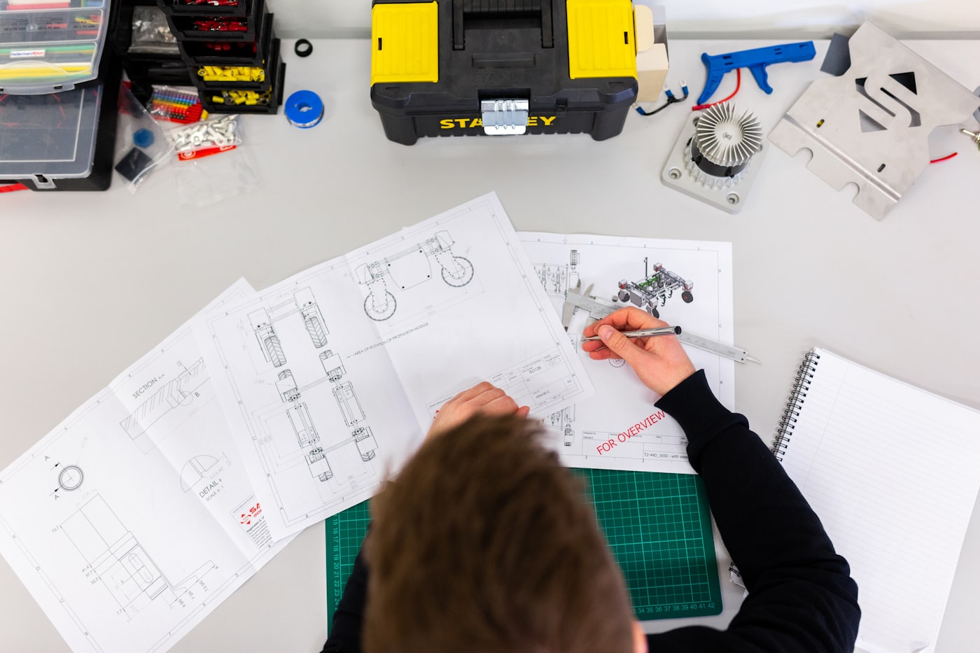 Engineer working through detail drawings and calipers