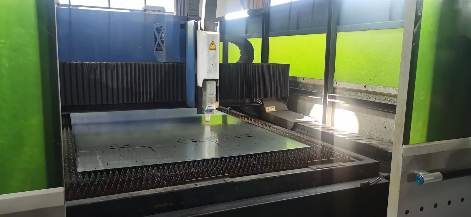 Fiber laser cutting through a nested sheet